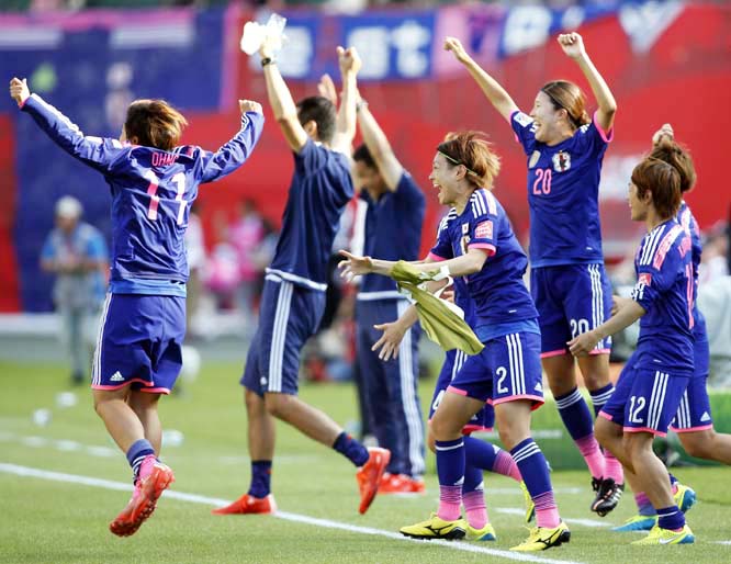 Japan players race onto the field to celebrate a 2-1 win over England in a semifinal in the FIFA Women's World Cup soccer tournament in Edmonton, Alberta, Canada on Wednesday.