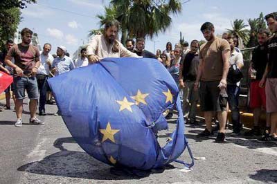 Anti-EU protesters burn a European Union flag in front of the European Parliament representation offices in Athens, Greece.