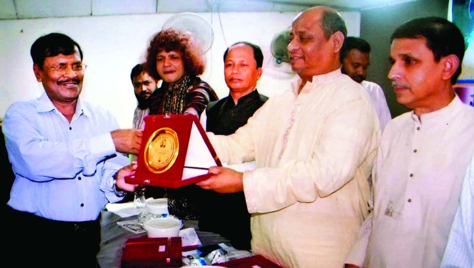 Whip of Jatiya Sangsad Shawkat Chowdhury, MP handing over Sher-e-Bangla Award to Dr Amar Biswas for his contribution in medical services at a ceremony organized by Bangladesh Sangbadik Kalyan Parishad at Bangladesh Shishu Kalyan Parishad Auditorium in the