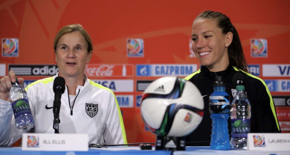 US coach Jill Ellis (left) and midfielder Lauren Holiday smile as they sit down for a news conference for the Women's World Cup soccer final in Vancouver, British Columbia, Canada on Saturday.