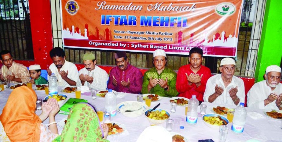 SYLHET: Sofiqul Azam Bhuiyan, former District Governor, Lions and other Lions offering Munajat at a iftar Mahfil with orphans at Raynagor Shishu Paribar orgainised by Lions Club, Sylhet on Sunday.