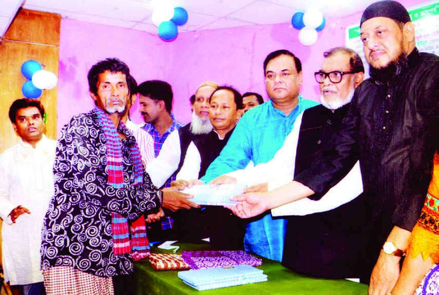 Liberation War Affairs Minister AKM Mozammel Haque distributing Eid clothes among the destitute at a function organized by Simanta Culture Academy at the Central Public Library in the city on Monday.