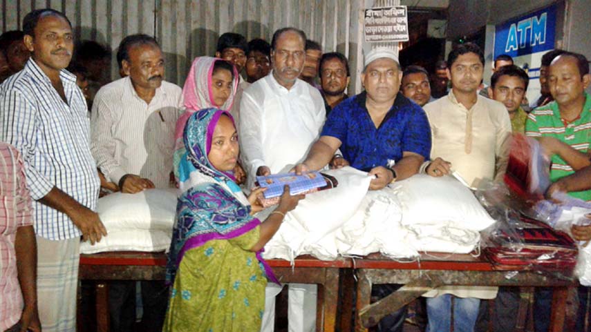 Chittagogong City Awami L eague leaders distributing relief goods among the flood victims in the city yesterday.