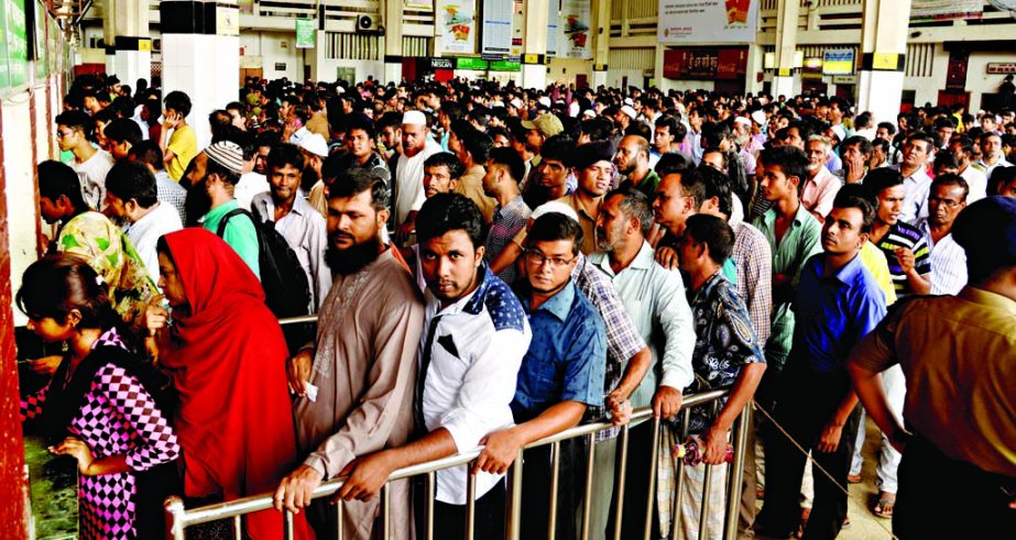 Thousands of home-bound people rush to Kamalapur Station to buy advance train tickets ahead of Eid festival on Thursday.