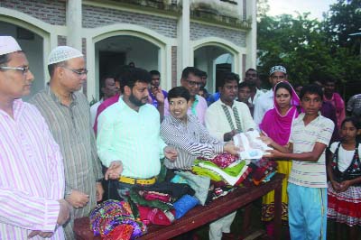 DINAJPUR: Shahadat Hossain Munna, Central Member Secretary, Bangladesh Cabel TV Viewers' Forum distributing new Eid dresses among orphan, poor and distress children at Birol Upazila on Thursday.