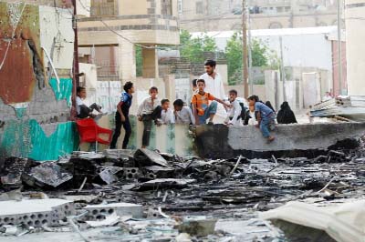 Yemeni chirldren look at a wedding hall which was reportedly hit by a Saudi-led coalition air strike in the capital Sanaa.