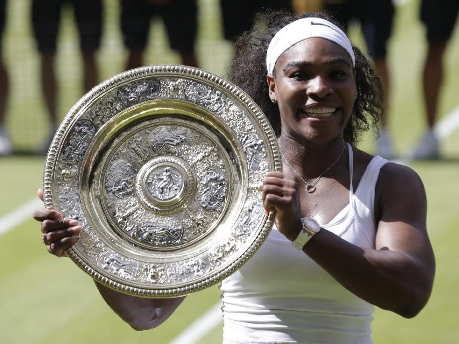 Serena Williams poses with the trophy after winning against Garbine Muguruza on Saturday.