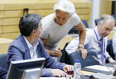 Greek Finance Minister Euclid Tsakalotos listens to International Monetary Fund (IMF) Managing Director Christine Lagarde (C) during an euro zone finance ministers meeting in Brussels, Belgium.