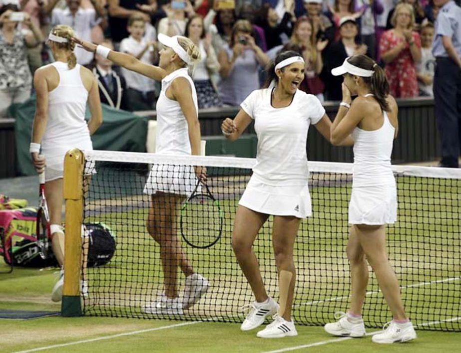 Martina Hingis of Switzerland (right) and Sania Mirza of India celebrate winning the women's doubles final against Ekaterina Makarova of Russia and Elena Vesnina of Russia at the All England Lawn Tennis Championships in Wimbledon, London on Saturday.