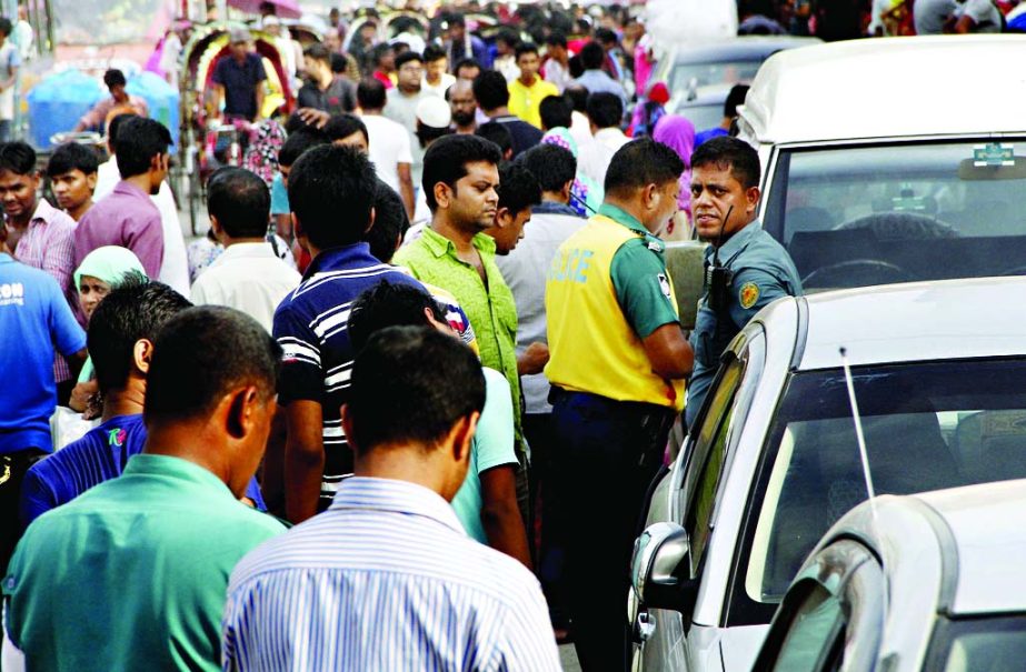 Traffic vigilance teams in action against illegal parking of vehicles near city market places to avert rush ahead of Eid. This photo was taken from New Market area on Sunday.