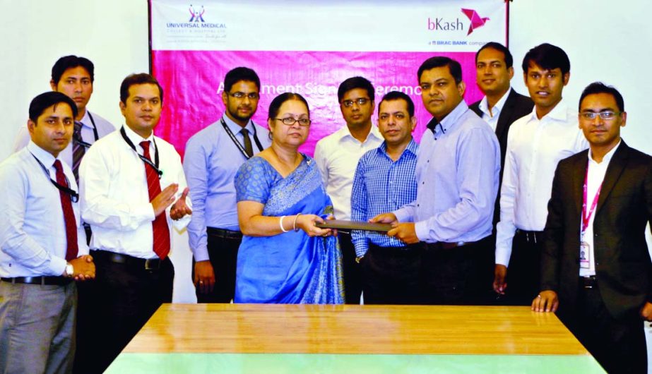 Rezaul Hossain, Chief Commercial Officer of bKash Limited and Priti Chakraborty, Chairman of Universal Medical College sign an agreement to facilitate patients' payment through bKash in the city recently.