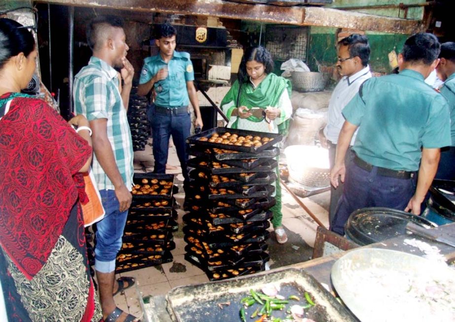 Magistrates Nazia Shirin conducting a mobile court against food adulteration at Aman Foods at Abdul Ali Hat in the city on Sunday.