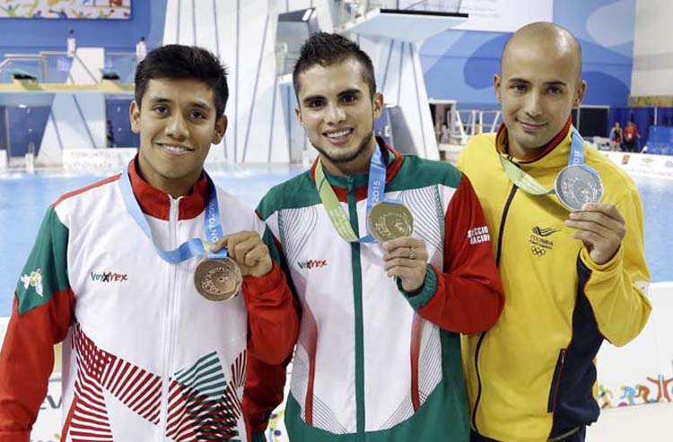 Gold medalist Ivan Garcia (center)of Mexico poses with silver medalist Victor Ortega (right) of Colombia, and bronze medalist Jonathan Ruvalcaba (left) of Mexico after the medal ceremony for the men's 10-meter platform diving event at the Pan Am Games in