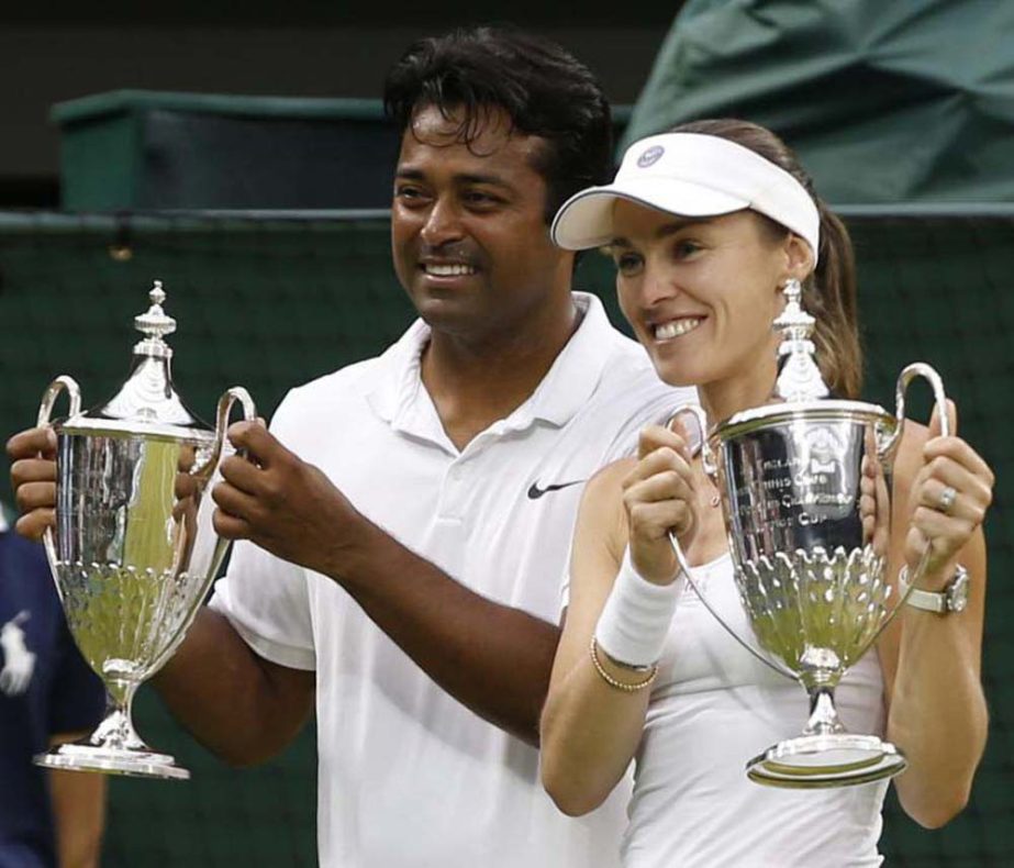Leander Paes of India (left) and Martina Hingis of Switzerland hold up the trophies after winning the mixed doubles final against Alexander Peya of Austria and Timea Babos of Hungary at the All England Lawn Tennis Championships in Wimbledon, London on Sun