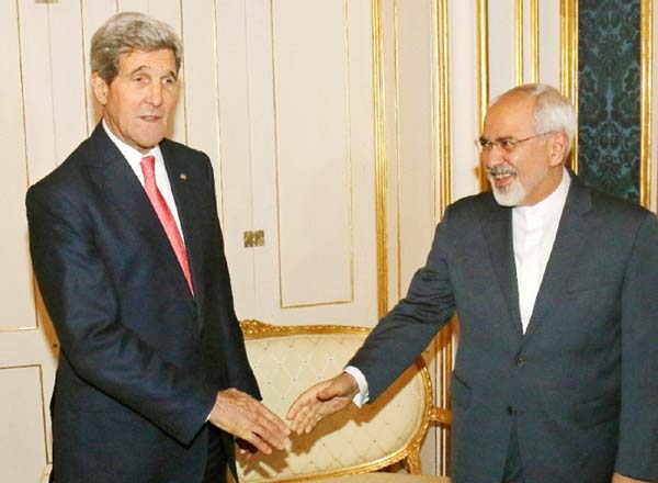 US Secretary of State John Kerry (L) and Iranian Foreign Minister Mohammad Javad Zarif shake hands prior to a bilateral meeting of the closed-door nuclear talks with Iran at the Palais Coburg in Vienna .