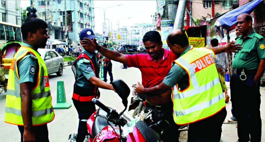 Fool-proof security measures clamped in the capital ahead of Eid-ul-Fitr. Photo shows a motorcycle rider being searched at Gabtali Check Post on Tuesday.