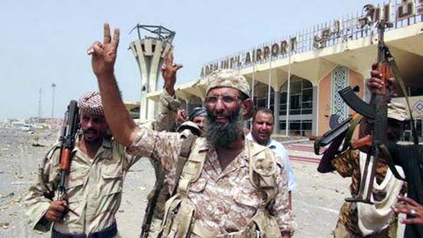 Southern Resistance fighters flash the victory sign at the international airport of Yemen's southern port city of Aden on Tuesday.