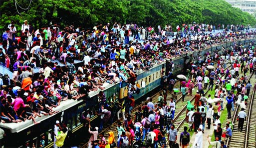 Risking even lives: Thousands trying to find a space either inside or on the rooftop of a train for their Eid journey. This photo was taken from Biman Bandar Rly Station on Thursday.