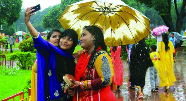 Children rush to the amusement park defying rain. The snap was taken on the third day of Eid from the city's Shishu Park.