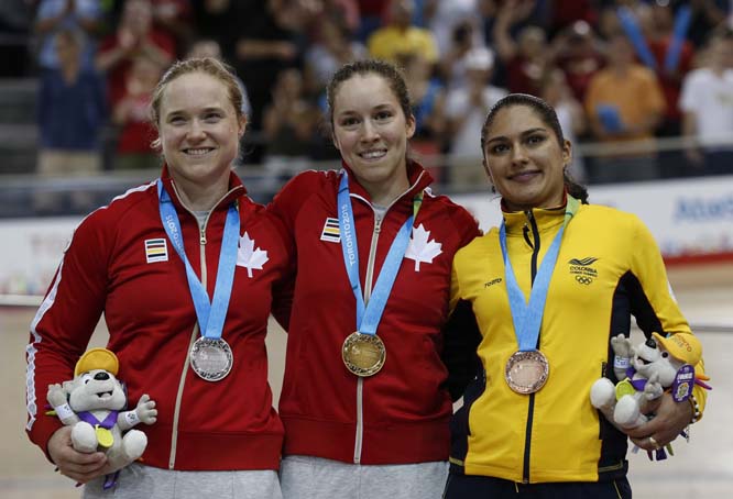 Gold medallist in women's sprint track cycling Canadian Monique Sullivan (center) poses with silver medallist Kate O'Brien (left) of Canada and bronze medallist Juliana Gaviria Rendon of Colombia at the Pan Am Games in Milton, Ontario on Sunday.