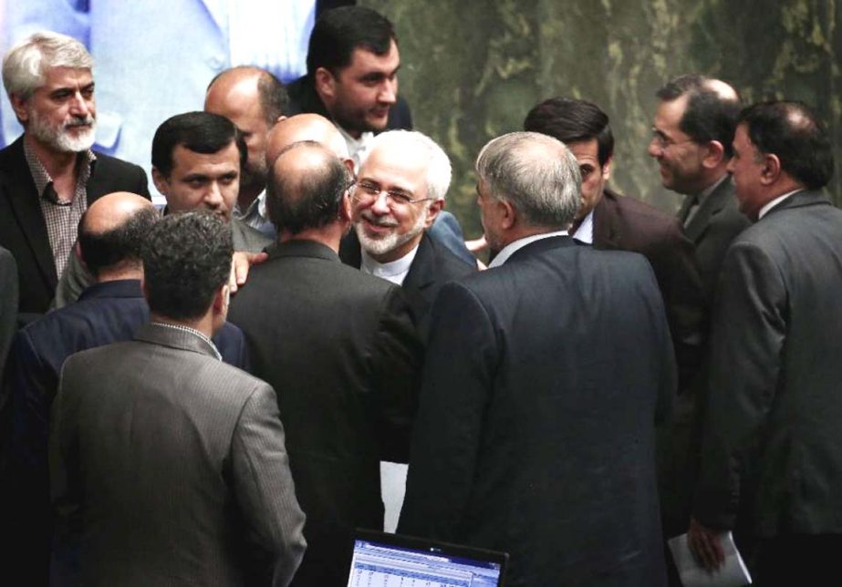 Iran's Foreign Minister Mohammad Javad Zarif (C) embraces MPs after delivering his speech in parliament in Tehran on Tuesday, defending last week's Vienna accord.