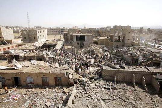 People and vendors gather on the rubble of shops destroyed by a Saudi-led air strike that hit a marketplace in Yemen's capital Sanaa on Monday.