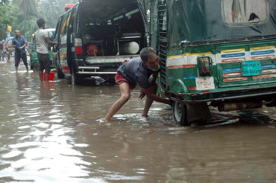 Motorised vehicles struggle through the stagnated water. The situation remains the same for long but the authority seemed to be blind to mitigate the woes of the road users. The snap was taken from in front of TB Hospital in the city's Chankharpul on Tue