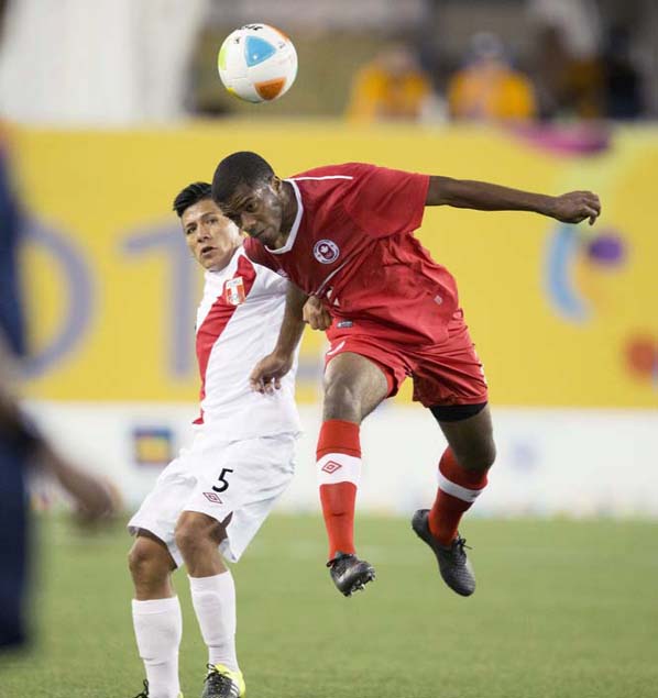 Canada's Jonathan Grant (2) heads the ball as Peru's Elsar Rodas (5) looks on during the Pan Am Games first half men's soccer match in Hamilton, Ontario on Monday.