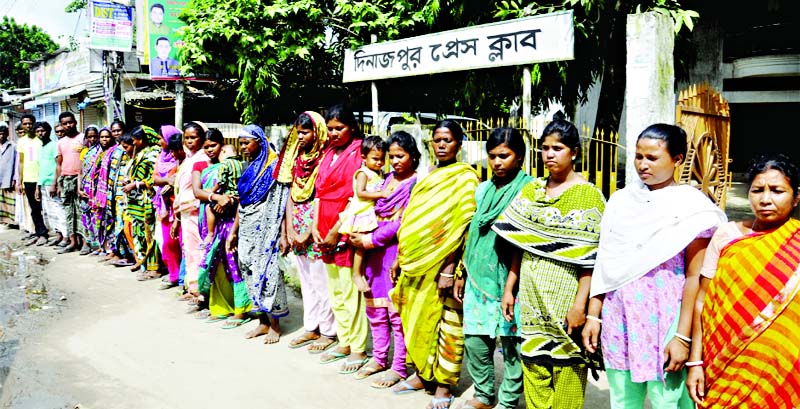 DINAJPUR: Tribal people formed a human chain on Tuesday in front of Dinajpur Press Club protesting attack on them.