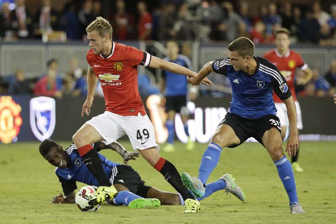 Manchester United forward James Wilson (49) takes the ball past San Jose Earthquakes midfielders Fatai Alashe (left) and Marc Pelosi (right) during the second half of an International Champions Cup soccer match on Tuesday.