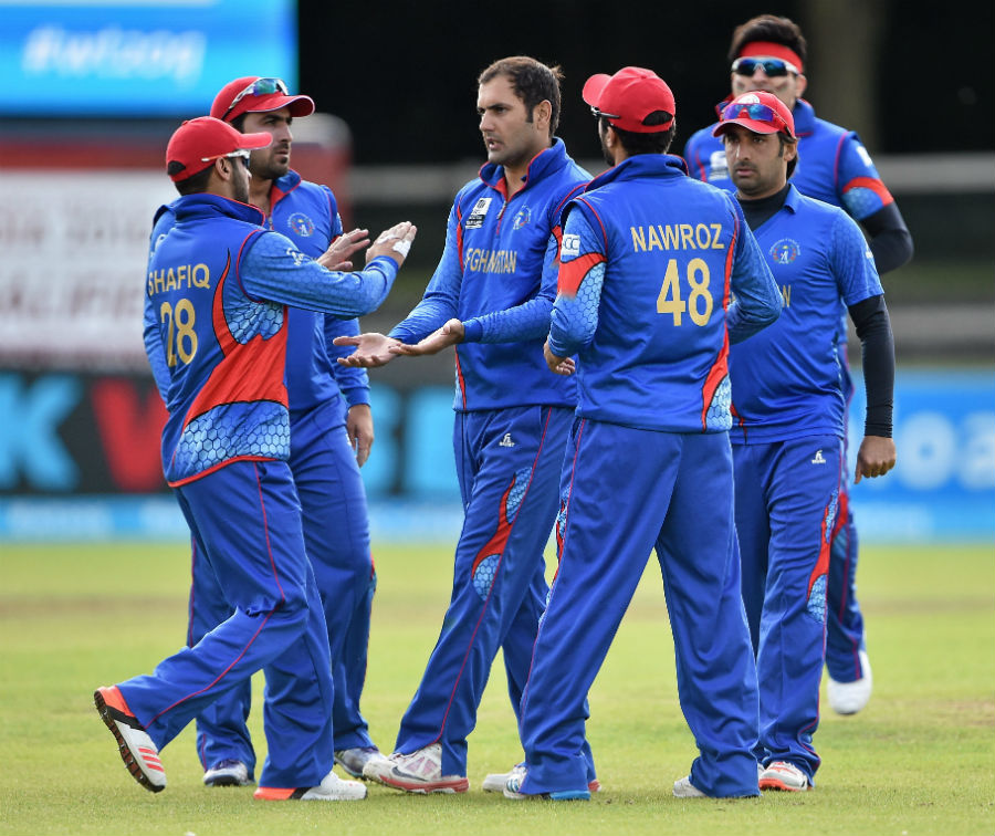 Mohammad Nabi is mobbed by his team-mates in the 3rd Play-off games of World T20 Qualifier between Afghanistan and Papua New Guinea in Dublin on Thursday.