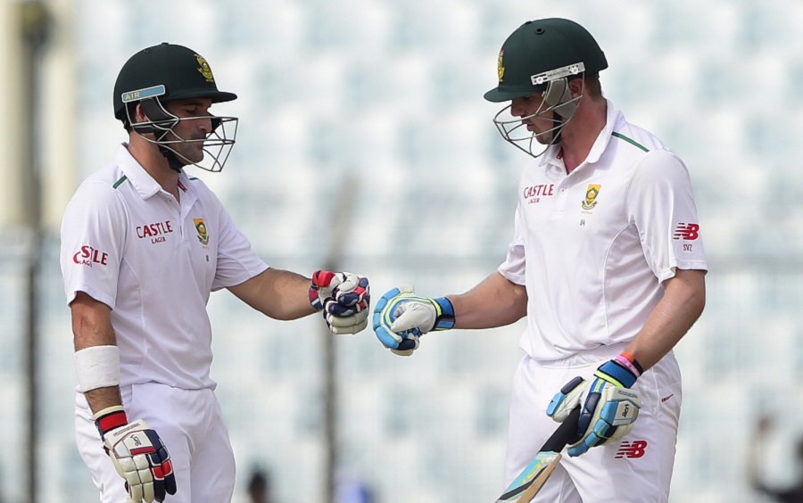 South Africa cricketer Dean Elgar (L) cheers up with his teammate Stiaan van Zyl (R) during the third day of the first cricket Test match between Bangladesh and South Africa at the Zahur Ahmed Chowdhury Stadium in Chittagong on Thursday.