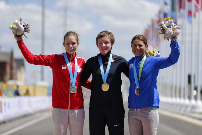 Gold medalist United States' Kelly Catlin (center) poses for photos with silver medalist Canada's Jasmin Glaesser (left) and bronze medalist El Salvador's Evelyn Garcia after the women's individual time trial cycling competition at the Pan Am Games in