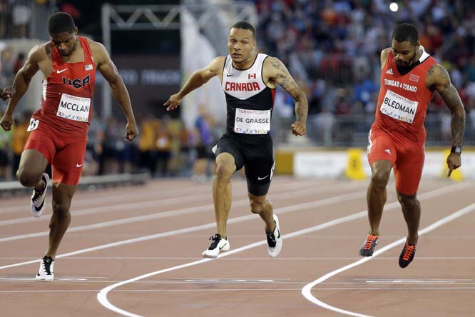 Canada's Andre De Grasse (center) Trinidad and Tobagoâ€™s Keston Bledman (right) and USA's Remontay Mcclain compete in the final of the men's 100 meter race at the Pan Am Games in Toronto on Wednesday. De Grasse won the gold medal in the event.