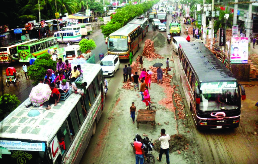 Pedestrians and passengers facing untold sufferings for traffic snarl due to keeping road repairing materials on the highway. The snap was taken from Savar Bus Stand on Friday.