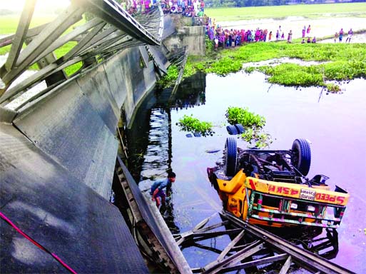 At least four people were injured when a goods-laden truck fell down into the Auliakhana River after some steel plates of a Bailey Bridge slipped at Jaldhaka in Nilphamari on Friday morning.