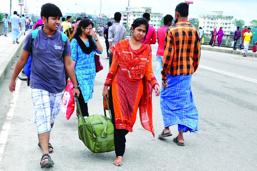 Passengers going to their respective destination on foot due to absence of transports as transport workers staged a demonstration on the two sides of Buriganga Bridge-1 in protest against increasing of toll. The snap was taken from Hasnabad area on Saturd