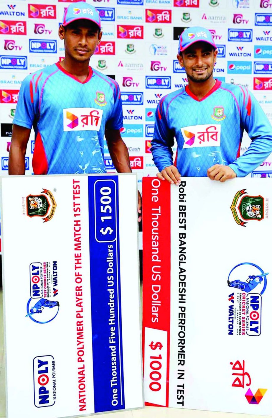 Mustafizur Rahman (left) with his Man of the Match award and Liton Das with his Robi Best Player award pose for a photo session at the Zahur Ahmed Chowdhury Stadium in Chittagong on Saturday. The first Test match between Bangladesh and South Africa ended