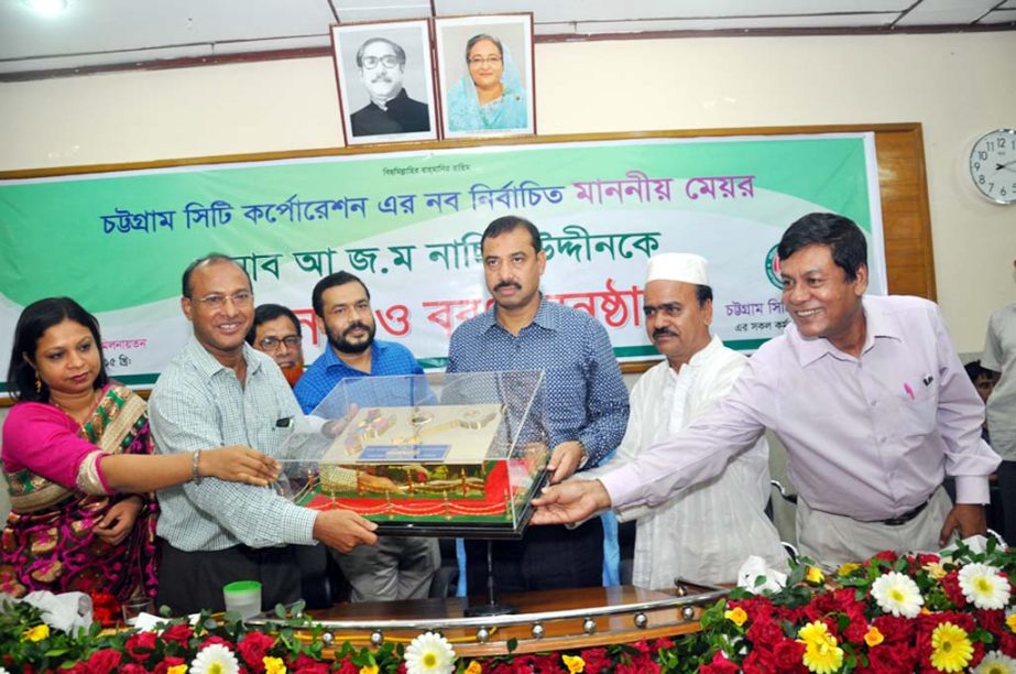 CCC Mayor AJM Nasiruddin receiving a crest from staff of the corporation on Sunday.