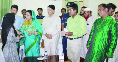 MYMENSINGH: Opposition leader Raushan Ershad MP distributing cash among the family members of jakat victim in Mymensingh District Circuit House Auditorium on Sunday.