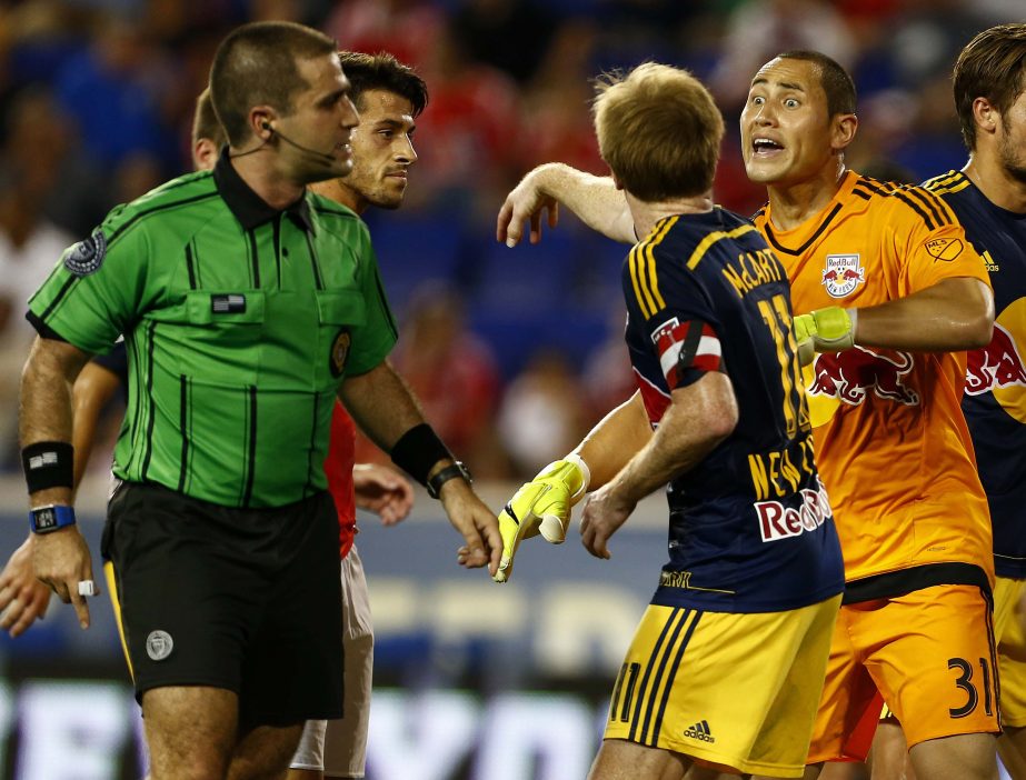 New York Red Bulls goalkeeper Luis Robles (31) is pushed back by teammate midfielder Dax McCarty (11) while arguing a call by referee Alex Chilowicz (left) during the first half of a soccer match against SL Benfica in the International Champions Cup in Ha