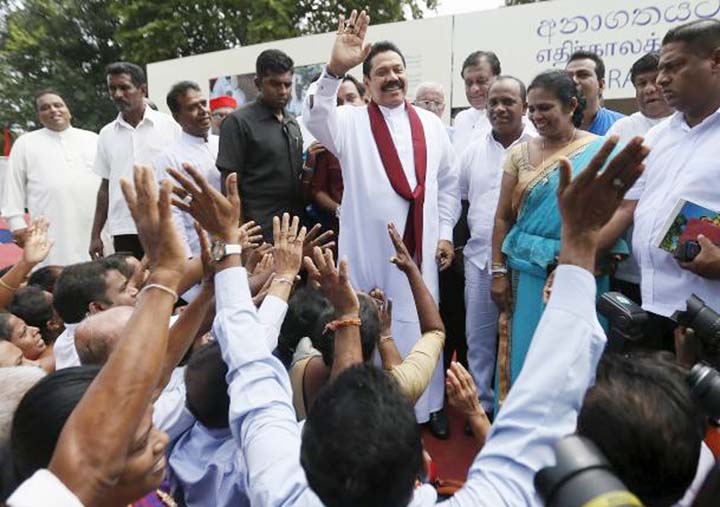 Sri Lanka's former president Mahinda Rajapaksa, who is contesting in the upcoming general election, waves at his supporters during the launch ceremony of his manifesto, in Colombo.