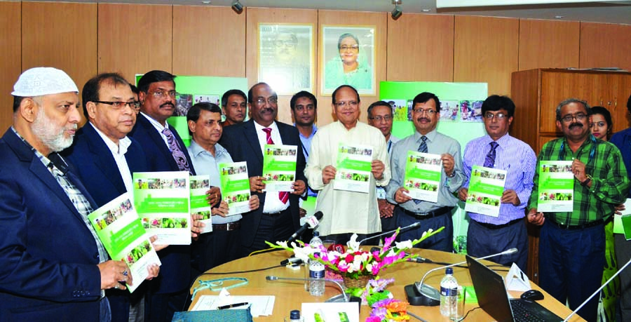 Bangladesh Bank Governor Dr Atiur Rahman poses with the declaration paper of agricultural and rural credit policy with a disbursement target of BDT 164 billion for fiscal year 2015 at the central bank in the capital on Monday.