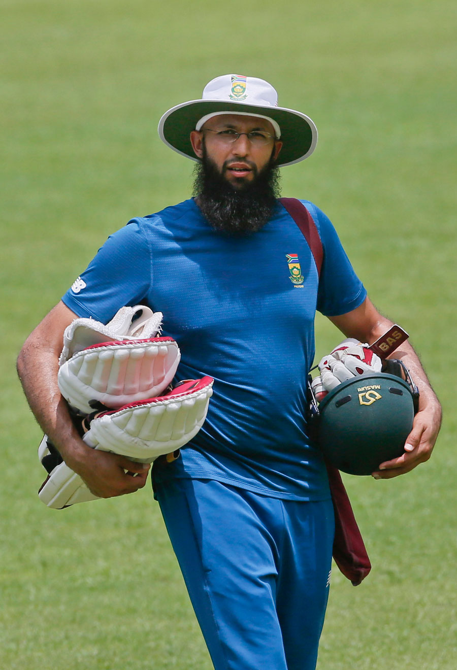 Hashim Amla carries his equipment during a training session at the Sher-e-Bangla National Cricket Stadium in Mirpur on Tuesday.