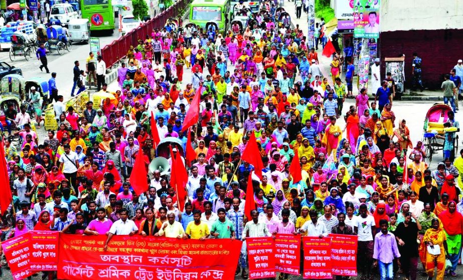 Garments Sramik Trade Union Kendra brought out a procession in the city on Tuesday demanding payment of outstanding salaries of workers of Swan Garments and reopening of garment factory.