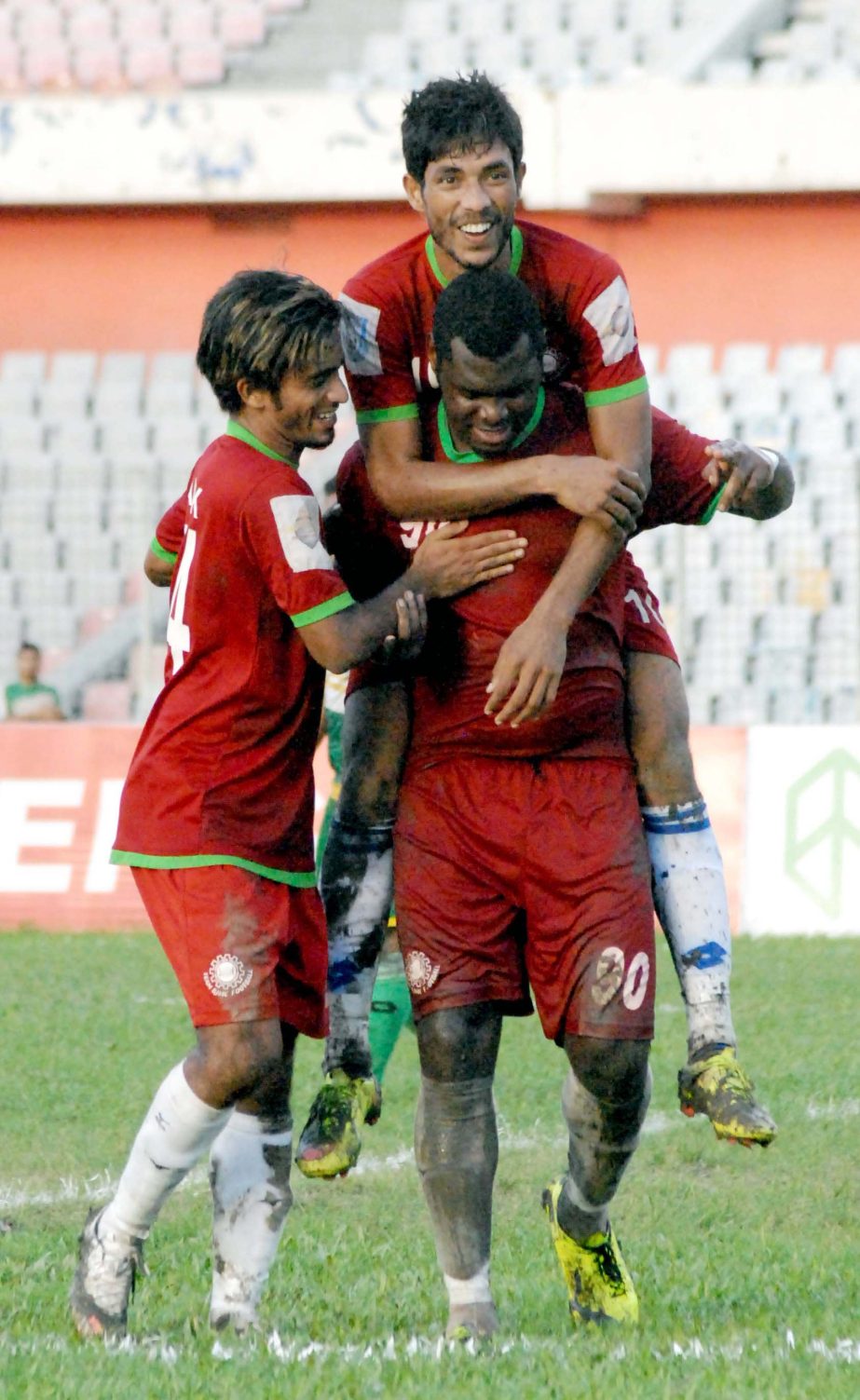 Players of Team BJMC celebrate after scoring a goal against Rahmatganj MFS in their football match of the Manyavar Bangladesh Premier League at the Bangabandhu National Stadium on Wednesday. Team BJMC beat Rahmatganj MFS by 3-1 goals.