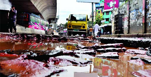 Huge cracks and potholes developed on the street adjacent to Hanif Flyover causing sufferings to commuters and pedestrians. This photo was taken from Swamibagh area on Wednesday.