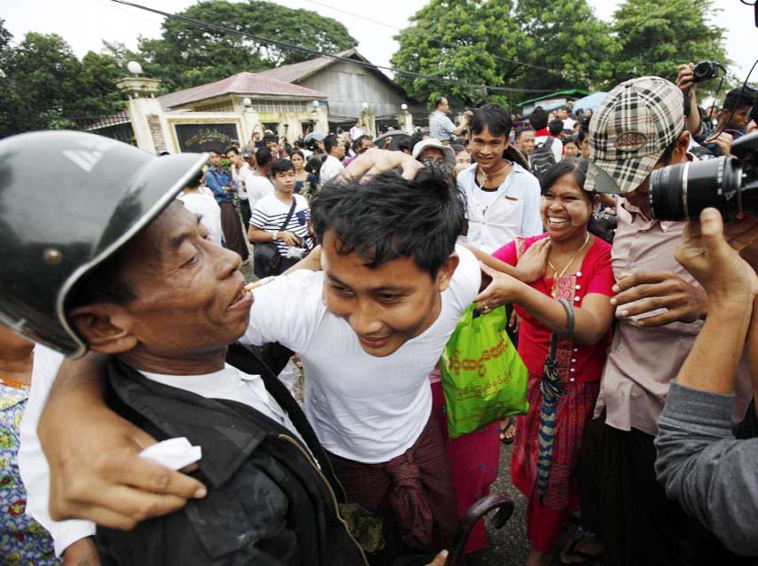 A released prisoner, centre, is welcomed by his family members outside Insein Prison, on Thursday in Yangon, Myanmar.