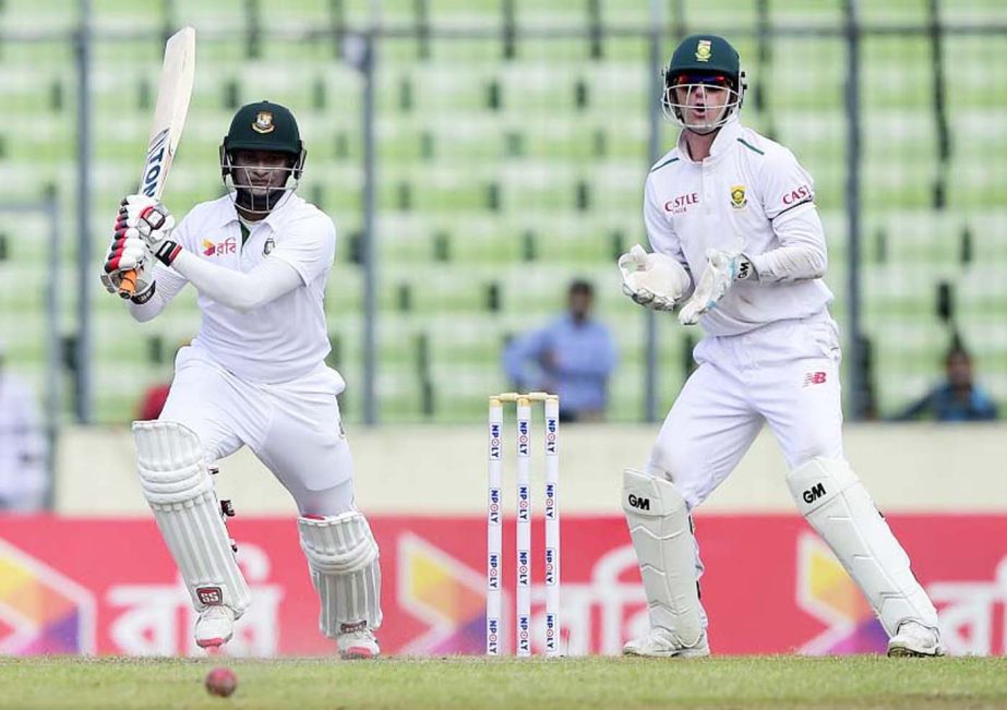Bangladesh cricketer Shakib Al Hasan (L) hits a shot as South Africa's wicketkeeper Dane Vilas (R) looks on during the first day of the second cricket Test match between Bangladesh and South Africa at the Sher-e-Bangla National Cricket Stadium in Mirpur