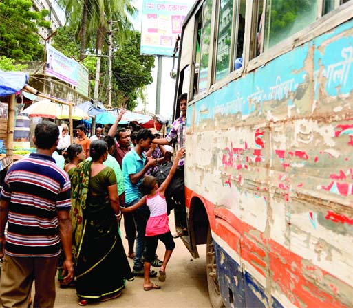 A helper is seen encouraging passengers to board a jam-packed bus on Gulistan-Abdullahpur-Gazipur route defying instruction of traffic authorities. But the passengers are allegedly disembarked on the road carelessly by the helpers when they reach their d